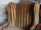 a chair that is sitting in front of a lamp