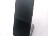 a cell phone that is sitting on top of a stand