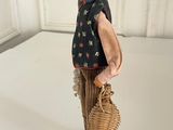 figurine of an old woman with a basket and a hat