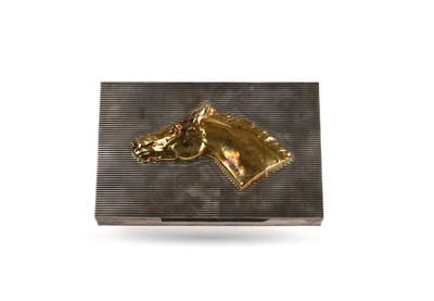 a close up of a gold horse head on a black box