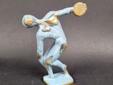 statue of a man holding a frisbee in his right hand