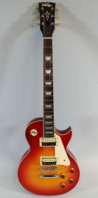 an electric guitar sitting on top of a white surface