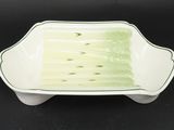 an image of a green and white dish on a black surface