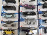 a lot of hot wheels cars on display on the table