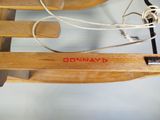 a wooden sled with a rope and a wooden sled attached to it