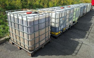 many containers that are sitting on the side of the road