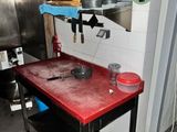 a red counter with pots and pans on it in a kitchen