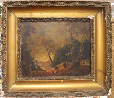 an oil painting of a wooded scene in a gold frame on a brick wall