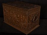 an old wooden chest with carvings on it on a black background