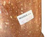 a stone vase with a sticker on it