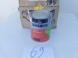 a can of paint sitting on a table next to a box of boxes