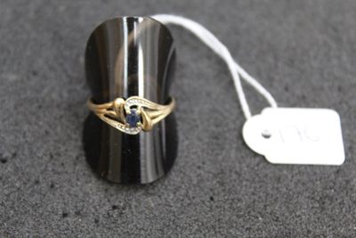 a gold ring with a diamond on it and a price tag