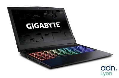 gigabyte laptop with a keyboard and mouse on top of it