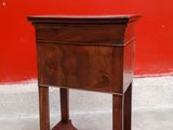 a small wooden table with a shelf on it