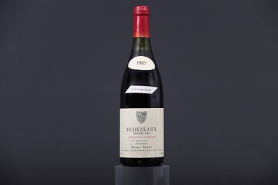 a bottle of wine sitting on top of a black table