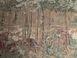 a picture of a tapestry with a picture of people in the woods