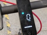 a close up of a bike ' s handlebar with a digital clock on it