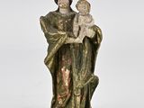 an old statue of a woman holding a baby in her arms