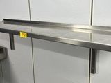 a stainless steel shelf with a yellow tag on it