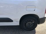 a white van that has a flat tire on the side of it