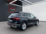 a black volkswagen suv parked in a showroom