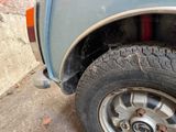 a close up of a tire on a car with a brick wall in the background