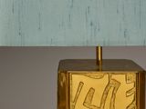 brass table lamp with a blue shade on a white background