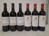 six bottles of wine are lined up on a table