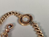 a close up of a gold chain with a clasp on it