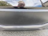 a reflection of a man in the rear of a car