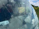 a reflection of clouds in the windshield of a car