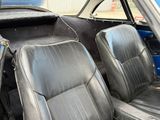 a black leather seat in the back of a blue car