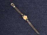 wrist watch on a blue cloth with a black strap