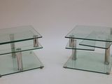 pair of glass side tables with metal legs
