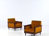 pair of mid century lounge chairs in the style of person