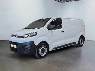 the white van is parked in a large room with a ceiling fan