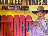 a poster of a man holding a gun in front of a wall