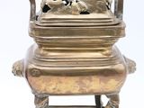 brass incense box with a bird on top of it on a stand