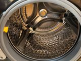 a close up of a washing machine with a person standing next to it