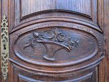 a wooden door with a metal handle and a plaque on it