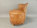 a chair that is made out of wood and has a seat made out of leather