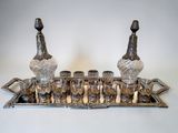 an image of a silver tray with glasses and a bottle on top of it