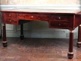 a wooden desk with two drawers on it in a room