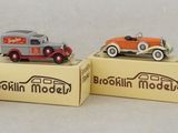 four toy cars that are sitting on top of a box