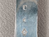 a close up of a silver watch on a cloth