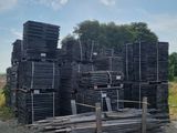 un gros tas de palettes en bois posé par terre