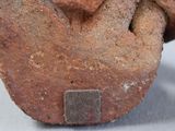 a close up of a piece of stone with a cross on it