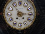 a clock that is on display in a glass case