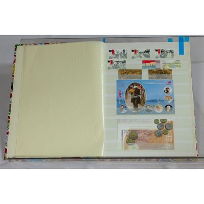 an open book with stamps on it on a table
