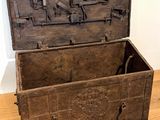 an old wooden chest sitting on a hard wood floor